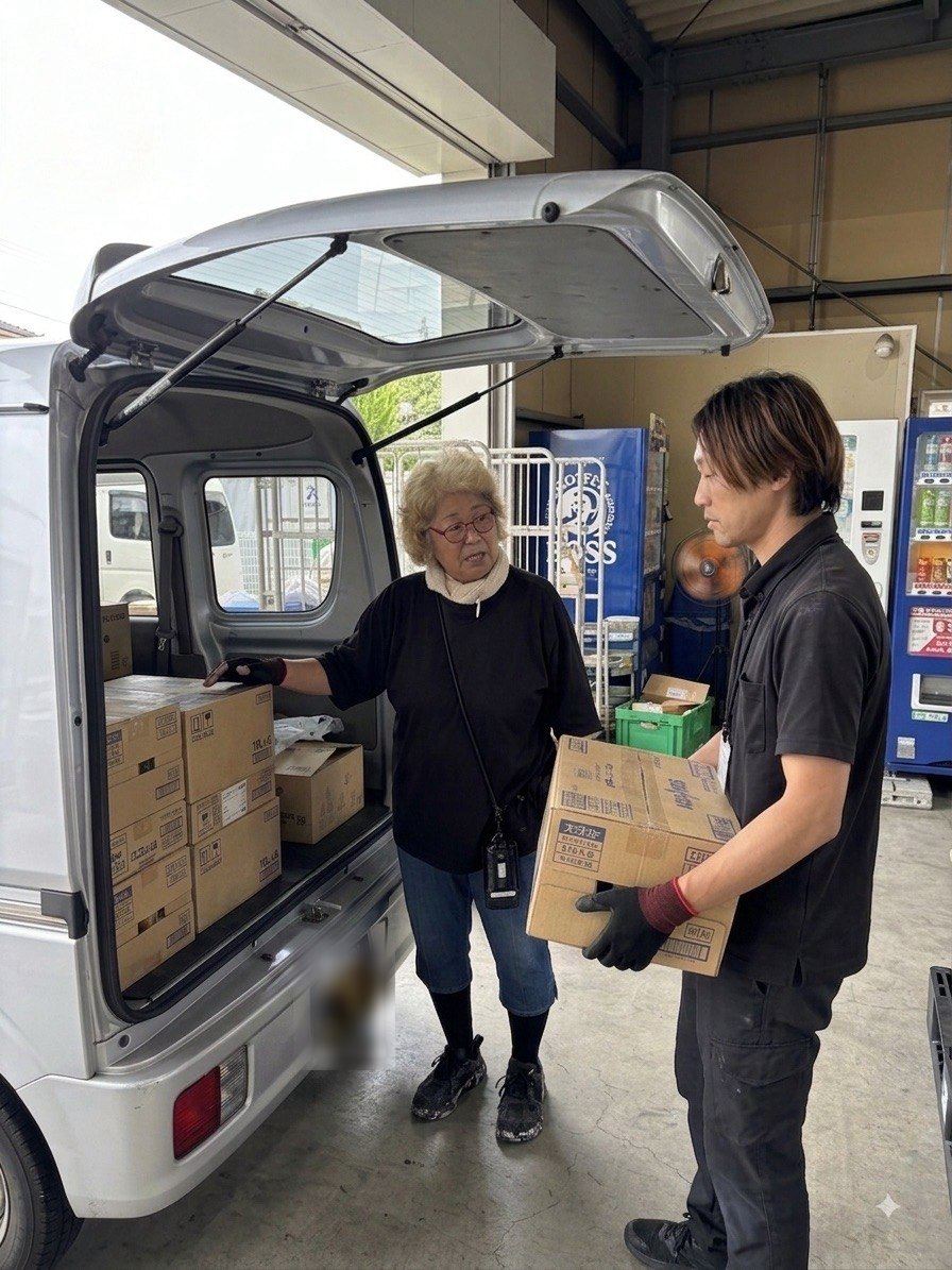 軽バンへの荷物の積み込みを先輩スタッフと確認する様子